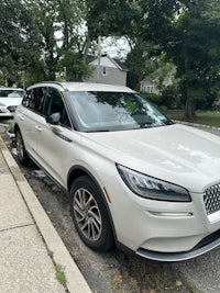 a white car parked on the side of a street