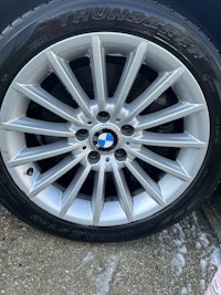 a bmw rim with a tire on the side of a car